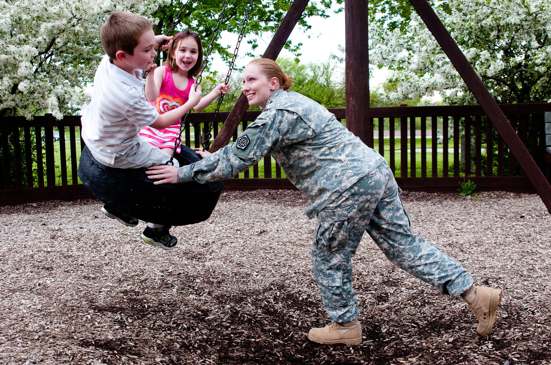Military member playing with family